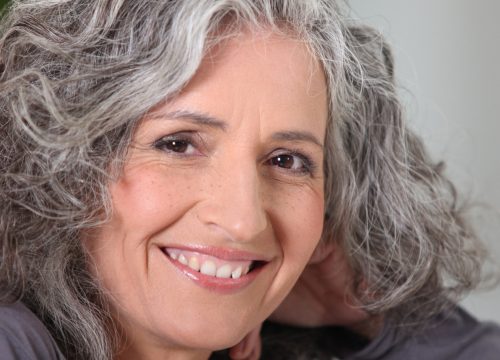 Photo of smiling older woman too with grey hair