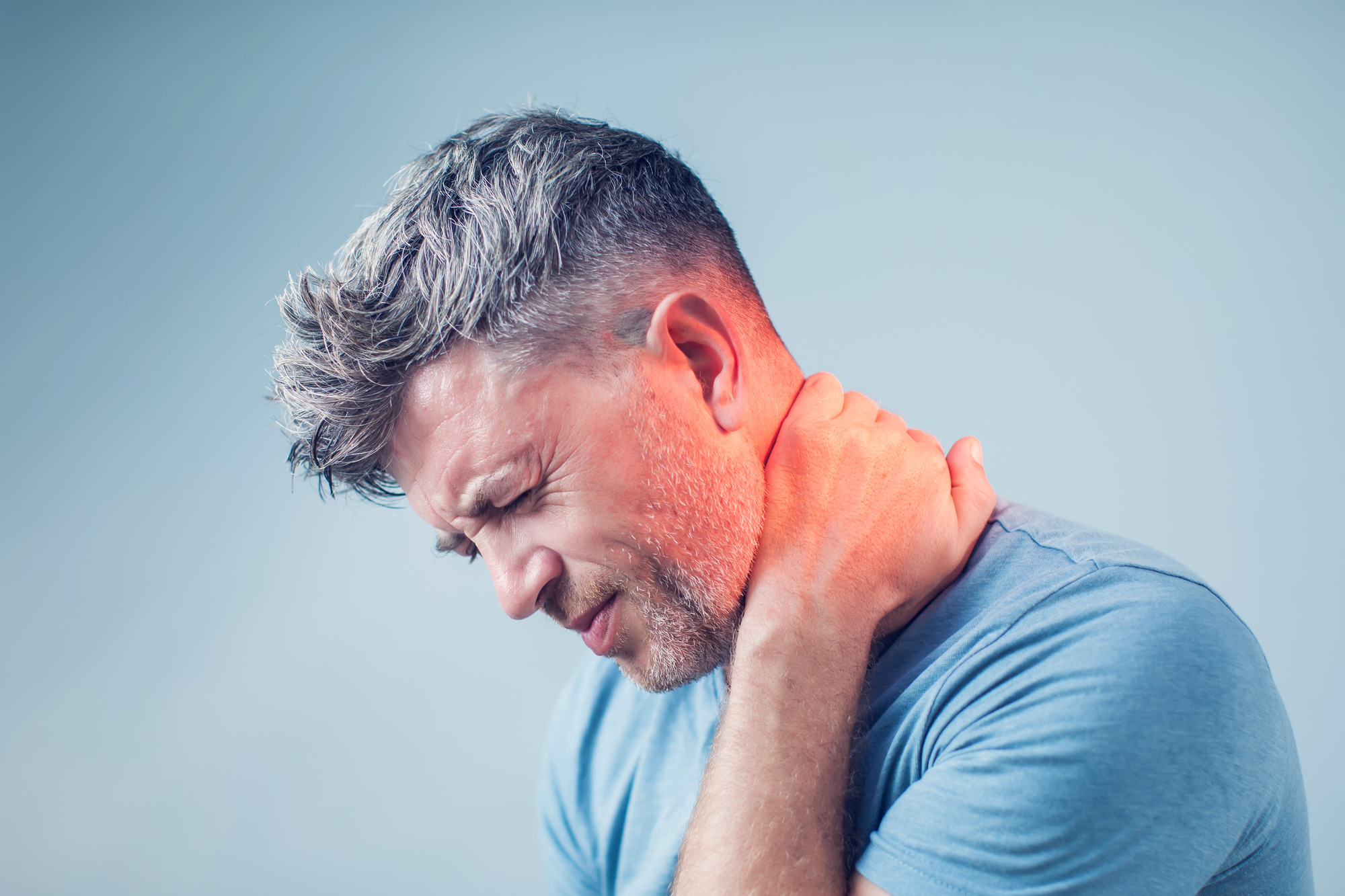 Photo of a man dealing with neck tension and pain
