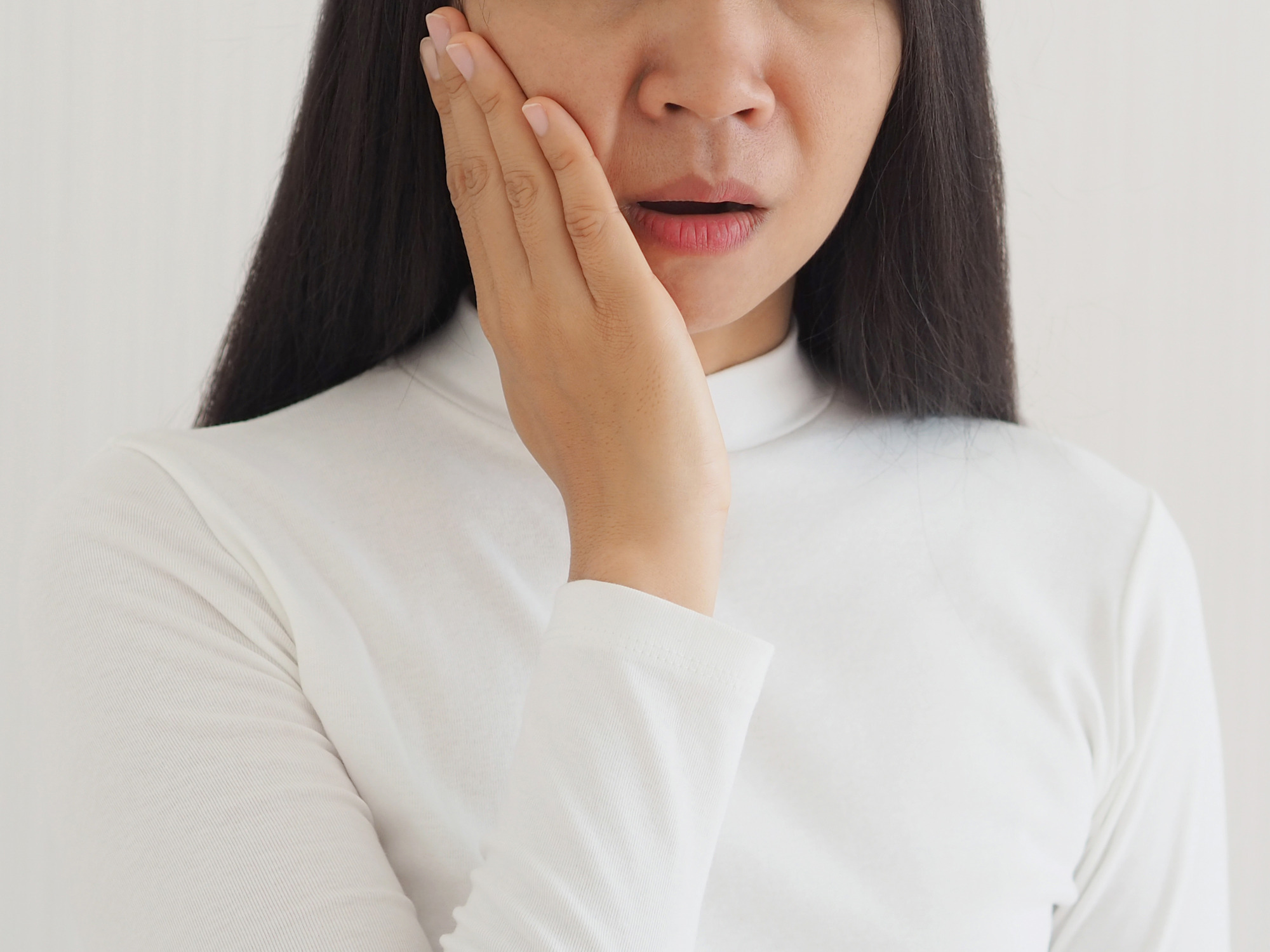 Photo of a woman dealing with jaw pain from TMD